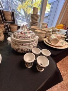 Collection of vintage floral china, tureens, and egg cups displayed for sale at a Grasons event