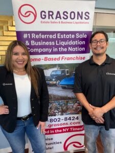 Grasons estate sale experts standing in front of a national business liquidation franchise banner